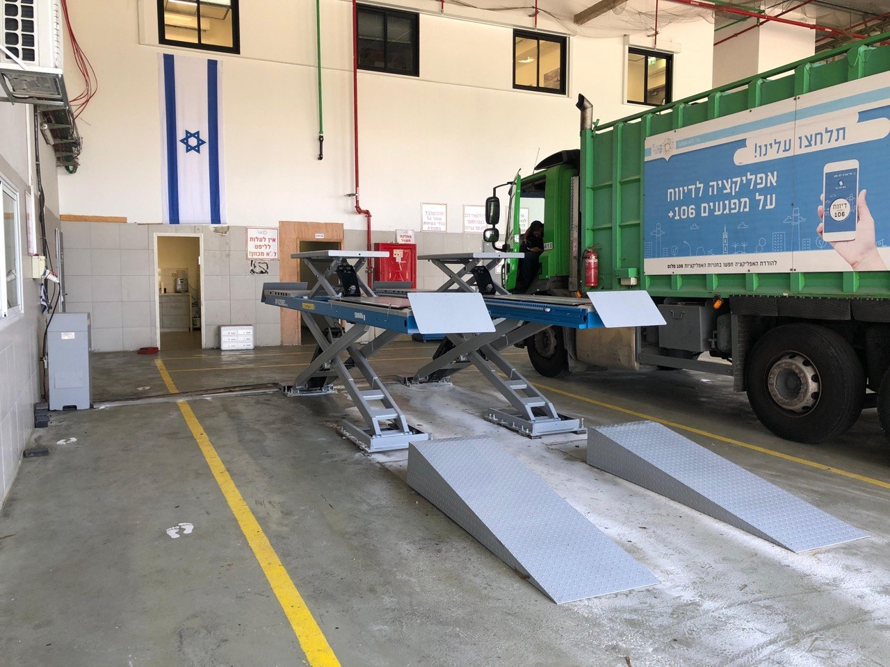 BMW X3 SUV on blue scissor lift